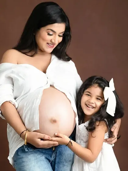 A joyful maternity photo celebrating the bond between a mother and her daughter. Capturing the excitement of a big sister-to-be is a key part of my family maternity sessions.