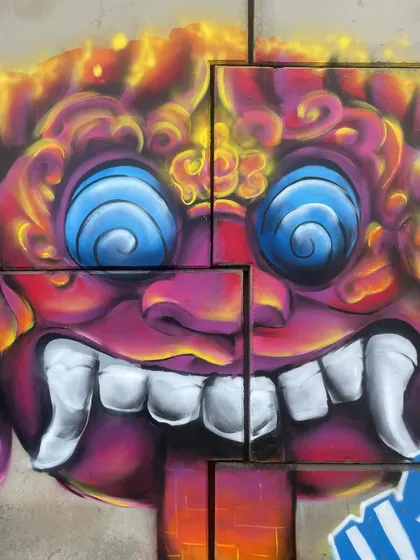 A close-up of the character's face. The swirling eyes and sharp teeth give it that wild energy I was going for.