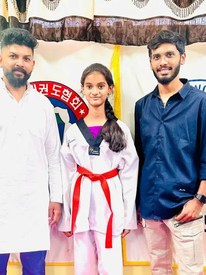 Another student celebrates her new red belt.