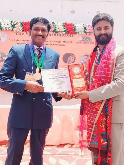 Presenting an award at an event organized by the Yog Sports Foundation. It is my privilege to recognize and encourage the next generation of yoga athletes.