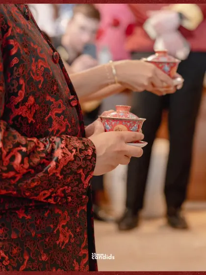 Holding history in porcelain cups. This close-up shot focuses on the details of the Chinese tea ceremony, a ritual steeped in respect and family connection.