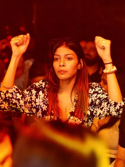 Hands up and feeling the power of the music.
