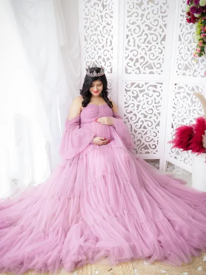 A duplicate of image 32, this portrait captures a mom-to-be seated gracefully in a voluminous lavender tulle gown.