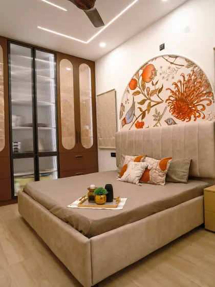 A beautifully balanced bedroom composition, with the artistic mural, plush bedding, and functional wardrobe creating a harmonious space.