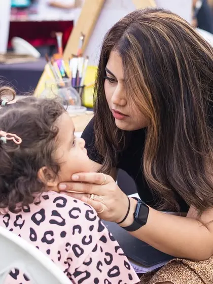 One of our artists having a sweet moment with a regular little client. We love building connections with the families we meet.