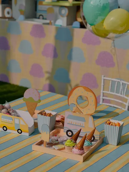 Another view of the kids' table, highlighting the custom-made food holders shaped like ice cream trucks.