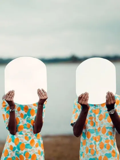 An abstract and creative pre-wedding shot where the couple holds up mirrors, reflecting the sky. It’s a playful and artistic take on a couple's portrait.