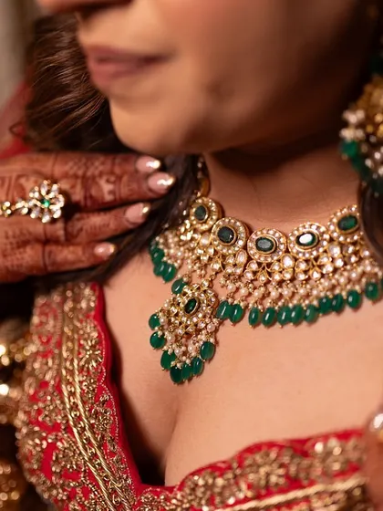 The details make the look. Here's a closer view of the exquisite polki and emerald necklace that added a touch of royal color to her traditional red bridal outfit.
