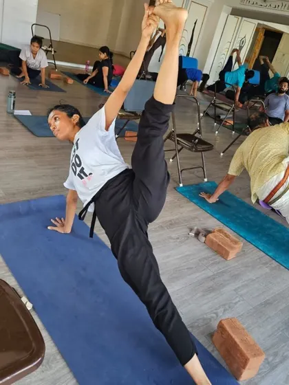 The splits, or Hanumanasana, is a challenging pose that our TTC students approach with mindful practice. This student demonstrates incredible flexibility and control.