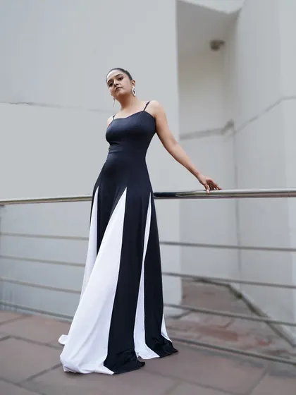 The full view of this stunning black and white gown. The contrasting panels create a visually interesting and flattering effect, making it a standout choice for a professional appearance.