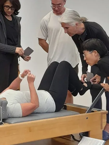 Observing and analyzing movement is a critical skill. Here, our group is focused on a demonstration, peeling back the layers of a seemingly simple exercise to understand its complexity.