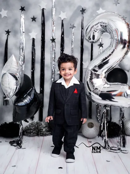 Turning two in style. A classic suit and a silver-and-black theme make for a dapper and celebratory toddler milestone session.