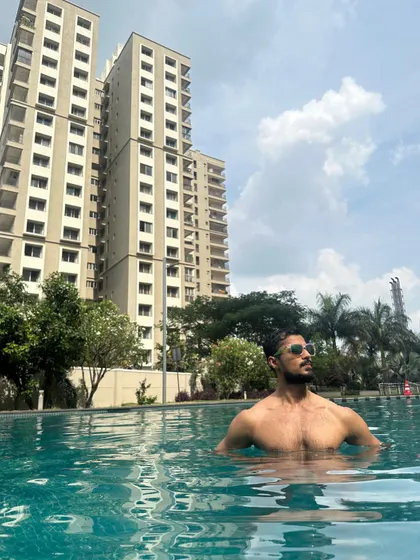 Enjoying a sunny day in the pool. This lifestyle shot is perfect for hospitality, travel, or swimwear brands.
