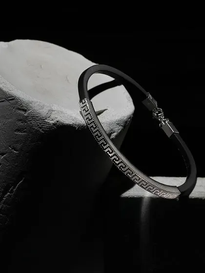 A beautiful men’s bracelet from Orionz Jewels, shot with dramatic, dark lighting. We placed it on a rough, stone-like prop to create a powerful contrast between the sleek jewelry and the rugged texture.