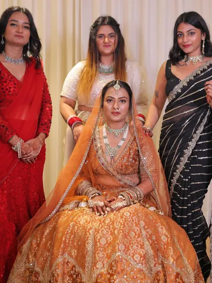 Posing with the bride and friends before the main event. My modern black saree provides a nice contrast to the bride's traditional orange lehenga.