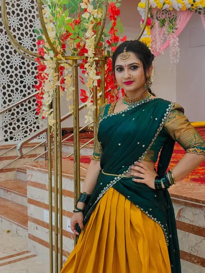 This pose highlights the rich texture of the silk skirt and the intricate border of the dupatta on this Langa Davani.