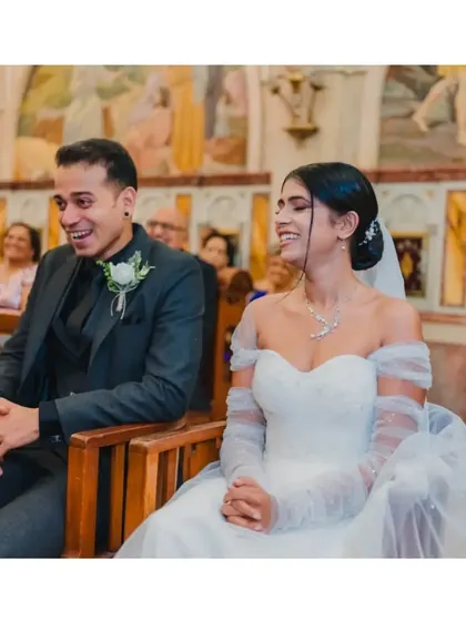 The couple's joyful smiles during their church ceremony, a candid moment that reflects their happiness.