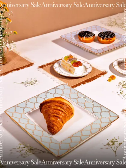 A stylish table setting featuring my Anardana collection. The combination of croissants, cakes, and coffee served on these elegant plates turns a simple meal into a sophisticated affair.