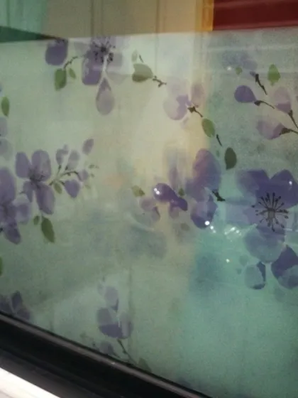 A delicate frosted film with a purple floral pattern. This design adds a soft, decorative touch to a window, offering privacy with a hint of color and elegance.