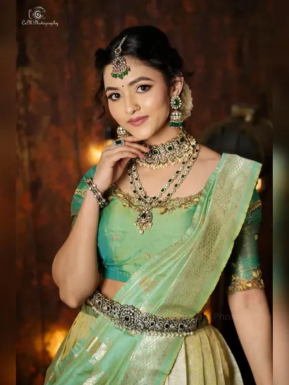 A classic pose from the ethnic wear photoshoot, highlighting the elegant drape of the half-saree style lehenga.