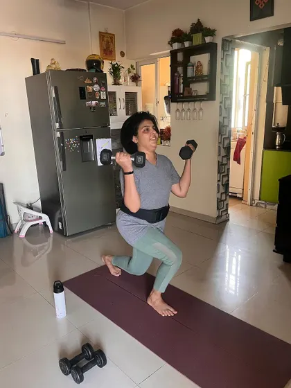 A client who is a cancer survivor demonstrates incredible strength and determination doing dumbbell lunges. Her journey is a powerful testament to how fitness can rebuild the body and spirit.