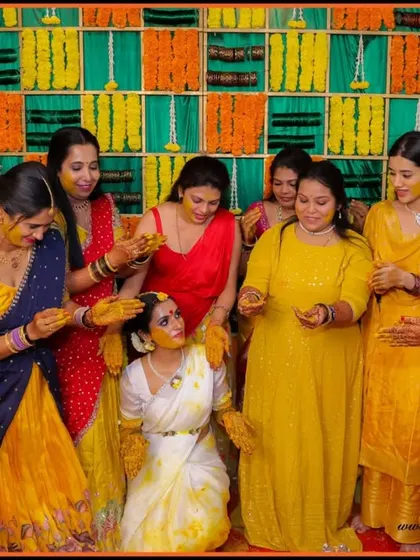 A beautiful moment of friends and family applying turmeric to the bride during her Haldi. We capture these traditions in a way that highlights the love and community surrounding the couple.