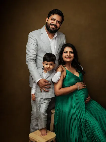 A classic family portrait taken during a maternity session. The family is elegantly dressed, creating a formal yet warm image that will become a cherished heirloom.