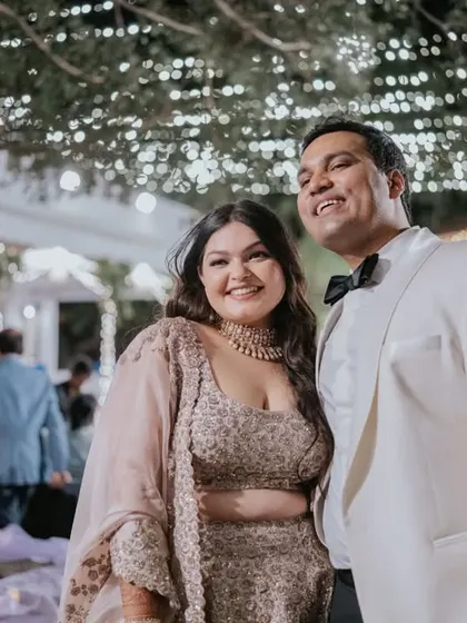 A portrait of the couple is a timeless memory. Ridhi and Prashanth stand on their candlelit stage, a moment of quiet elegance amidst their romantic cocktail party.