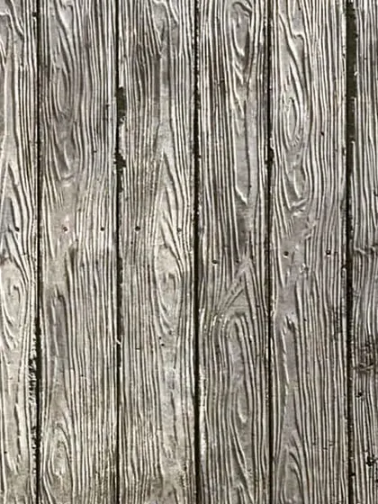 The final result of the wood-textured concrete. The surface captures the fine grain and texture of the wooden planks used in the formwork.