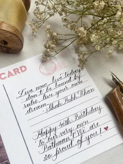 Everything old-school. This custom postcard features a handwritten birthday message and a quote from Shah Rukh Khan, wrapped in vellum and sealed with a red wax stamp for a vintage feel.