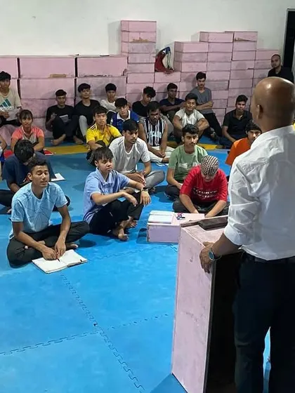 A wide shot of a workshop on World Taekwondo rules and regulations. We believe a true martial artist understands the sport from all angles, including its governance and scoring.