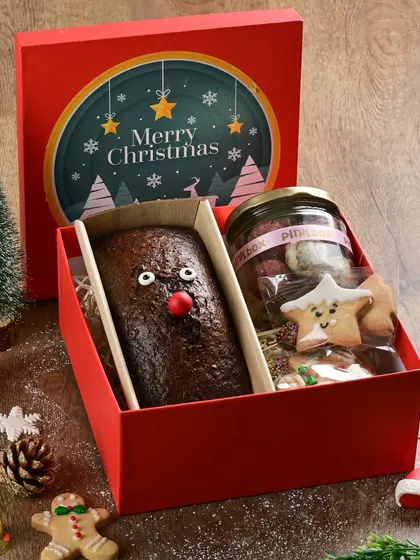 Our Christmas treat box is the perfect last-minute gift. It includes a reindeer-themed mini plum cake and an assortment of our festive cookies.