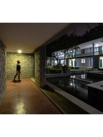 A night view of the ward block from across the water, showing how the lighting creates a serene and peaceful ambiance.