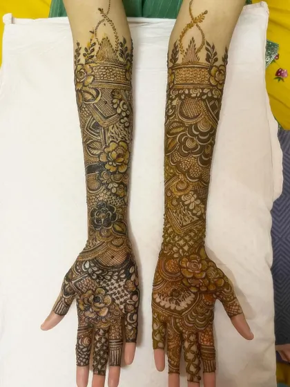 A full view of the elbow-length bridal henna, showcasing the extensive and detailed work.