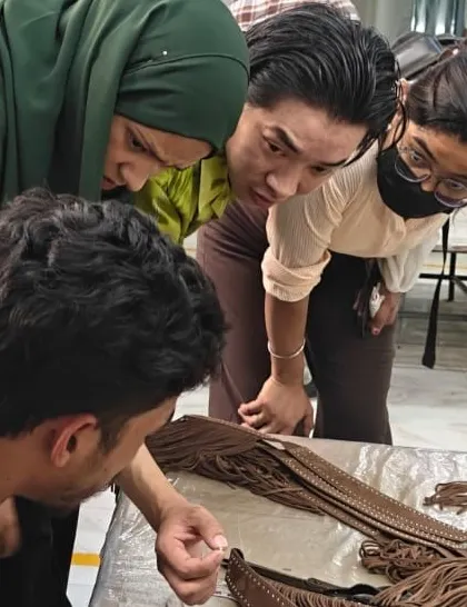 At Savi Fashion Apparel, students get a close look at leather crafting techniques, understanding the details that go into producing high-quality leather goods for global brands.