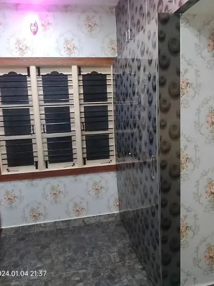 A bedroom with two different but complementary floral wallpapers.