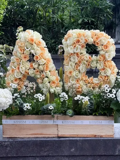 I create bold, personalized statements with flowers. These custom floral monograms, crafted from hundreds of fresh peach and cream roses, are a stunning way to celebrate a wedding, anniversary, or special milestone.