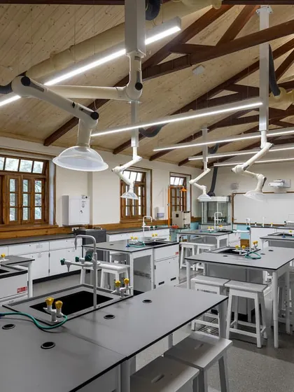 This image captures the blend of old and new in the science labs, with restored wooden window frames providing a backdrop for modern scientific equipment.
