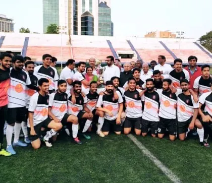 The team gathered on the field for a group photograph. Moments like these, celebrating with the entire squad and honored guests, are what build a strong and lasting club culture.