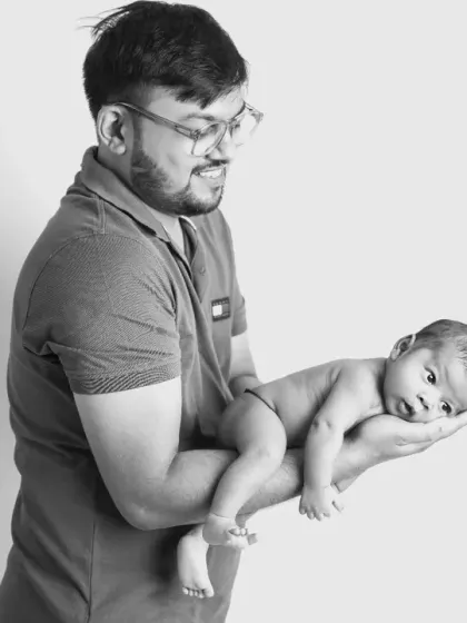 The same powerful pose in black and white. Stripping away the color emphasizes the textures and the emotional connection between father and child, creating a truly artistic portrait.