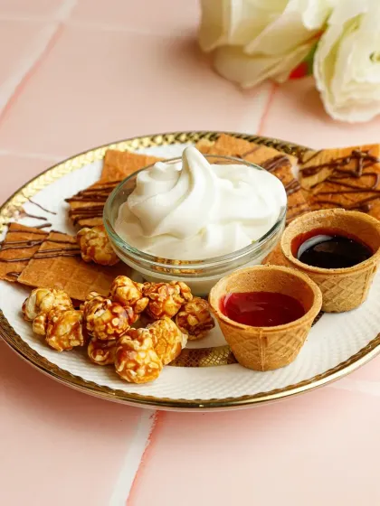 A playful and inventive dessert. Our Nachos Ice Cream combines sweet and savoury with crispy, cinnamon-dusted nachos, soft-serve ice cream, caramel popcorn, and dipping sauces.