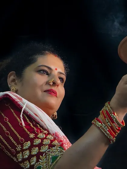 Another shot from the Durga Pooja series, showcasing the traditional red and white saree and the smoky dhunuchi for an authentic feel.