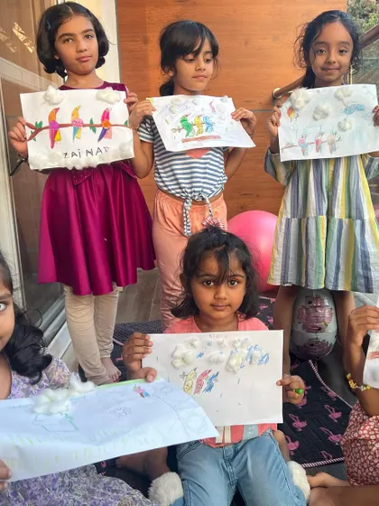 Our little birdies showing off the bird art they made. We talked all about birds, chirped a little, and then brought them to life on paper.
