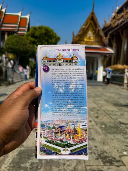 Holding a guide to The Grand Palace. I make sure we cover all the important historical sites during our city tour.