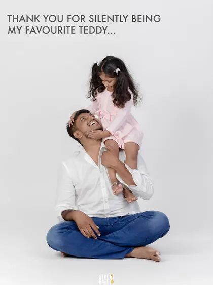 A daughter sits on her father's shoulders, a perfect picture of trust and love.