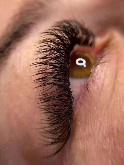 The details make the difference. This extreme close-up showcases the precision required for eyelash extensions, a highly sought-after skill that we cover in-depth in our cosmetology program.