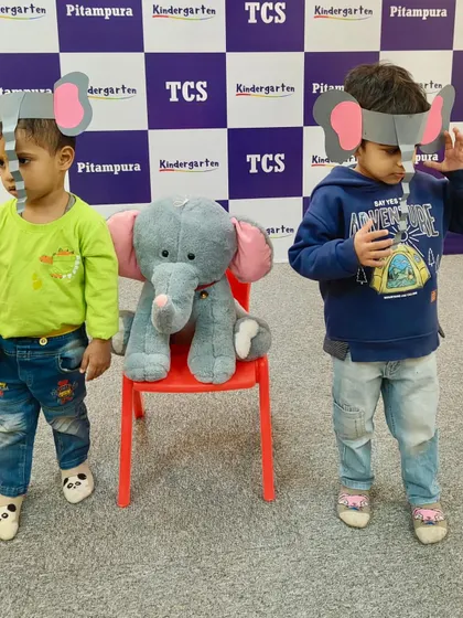 Two boys in their elephant masks stand proudly. Our craft and role-play activities make learning new concepts an exciting adventure for every child.