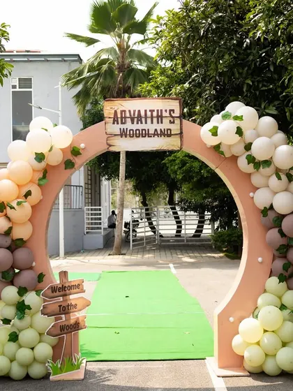 A grand entrance arch for Advaith's woodland party. The arch is decorated with organic balloon garlands in soft, earthy tones, setting a rustic and elegant mood for the celebration.