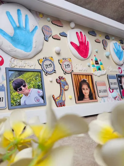 Preserve those precious memories forever with our custom impression frames. This one captures the handprints of three siblings, along with their photos and birth details.