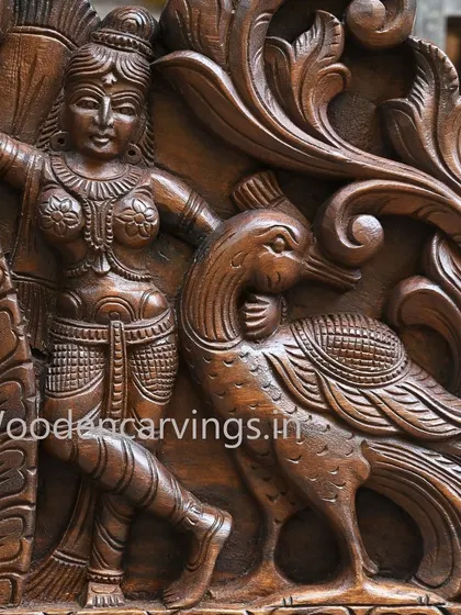 Detail of an attendant and a peacock from the side of the Krishna panel, showcasing the dynamic composition and deep relief work.